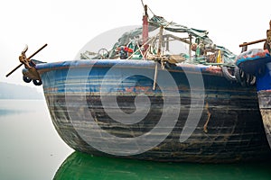 A large fishing boat parked on the river