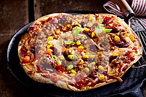 Large flat bread tortilla pizza in pan