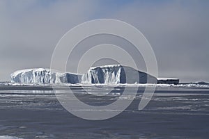 Large flat iceberg in the waters of the Antarctic