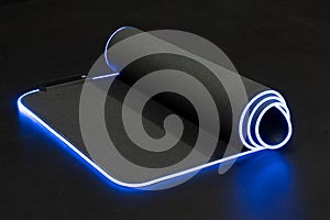 Large flexible backlit mouse pad on a dark background