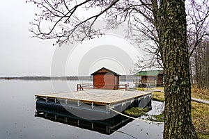 Large floating wooden platforms on pontoons with holiday houses in the lake for leisure and fishing