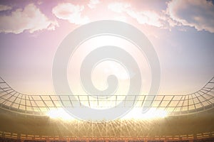 Large football stadium with spotlights under morning sky