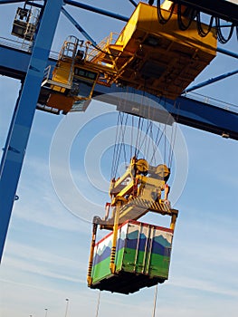 Large forklift stacking containers in port