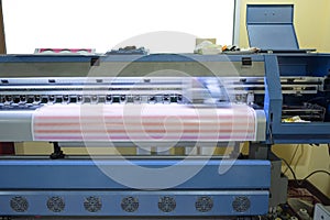 Large format inkjet printer working on sticker sheets