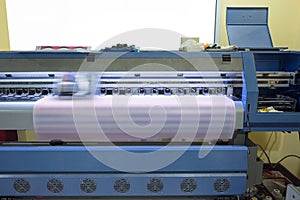 Large format inkjet printer working on sticker sheets