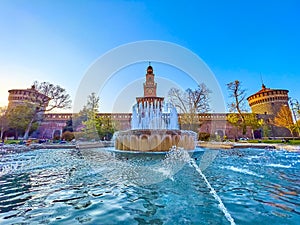 The large fountain on Piazza Castello and a view on Sforza`s Castle, Milan, Italy