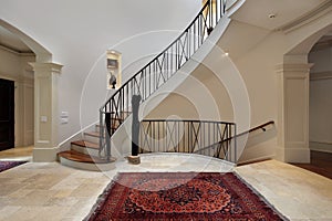Large foyer with circular staircase photo