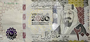 Large fragment of the obverse side of 200 two hundred Saudi riyals banknote features King Abdul Aziz Al Saud the founder of the