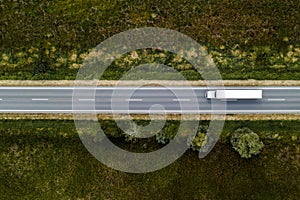 Large freight transporter semi-truck on the road, aerial view