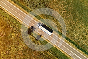 Large freight transporter semi-truck on the road, aerial view