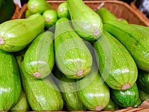 Large  fresh young vegetable marrows in the supermarket closeup.