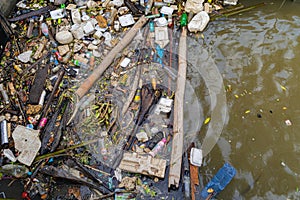 Large of garbage dump, plastic bags, rubbish, and trash in river or lake in urban area in environmental pollution concept.