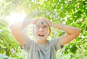 A large garden grape snail crawls over the girl`s face