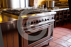 large gas kitchen stove in kitchen of restaurant or cafe