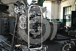 Large gears of a truck. The engine and shaft with gears are disassembled. Black, metal engine parts