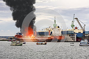Large general cargo ship for logistic import export goods and other the explosion and had a lot of fire and smoke while moored at