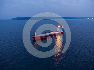 Large general cargo ship tanker bulk carrier, aerial view at night