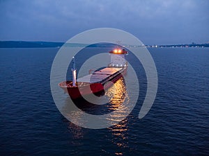 Large general cargo ship tanker bulk carrier, aerial view at night