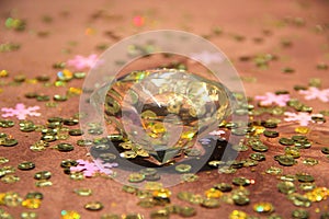 A large glass crystal against a wooden background. Sparkling, shining. Sparkling Frontiers.