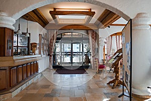 Large glass doors at entrance of alpine luxury hotel