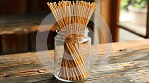 A large glass jar filled with allnatural bamboo incense sticks each handdipped in essential oils for a longlasting and photo