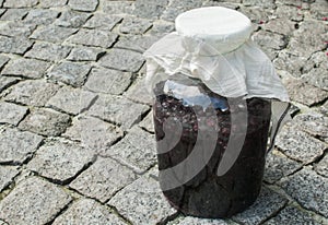 Large glass jar with sugar soaked sour cherries for alcohol fermentation