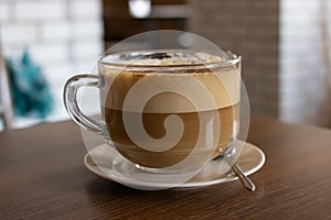 Large glass mug with coffee with milk