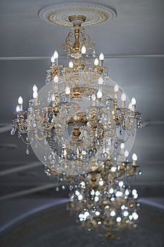 Large gold-plated crystal chandeliers in a restaurant