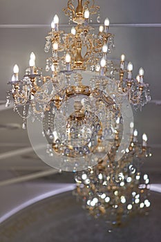 Large gold-plated crystal chandeliers in a restaurant