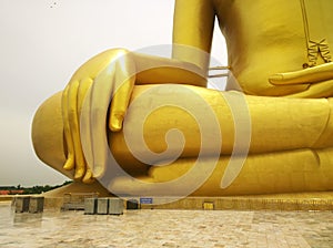 Large golden buddha statue with his big hand and fingers at WAT MUANG Muang Temple Ang Thong Province, THAILAND