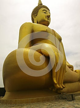 Large golden buddha statue with his big hand and fingers at WAT MUANG Muang Temple Ang Thong Province, THAILAND