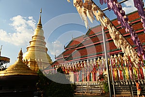 The large golden pagoda is Phra That Hariphunchai .