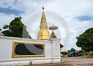 Large golden temple with sky background, Name is Phra Maha Chedi Srivang Chai, Located in Lamphun, Thailand.