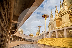 Large golden temple with sky background, Name is Phra Maha Chedi Srivang Chai, Located in Lamphun, Thailand.