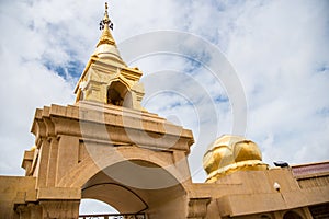 Large golden temple with sky background, Name is Phra Maha Chedi Srivang Chai, Located in Lamphun, Thailand.