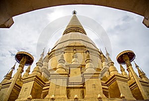 Large golden temple with sky background, Name is Phra Maha Chedi Srivang Chai, Located in Lamphun, Thailand.