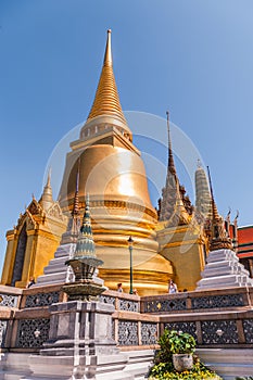 Large Golden Temple Spire against a dark blue sky at Grand Palace, Thailand
