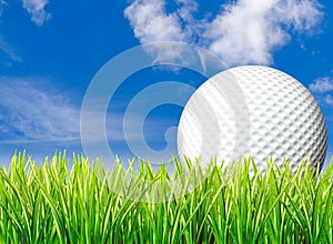 Large golf ball, grass & sky