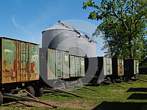 Large Grain Silos behind Peanut Wagons and a Pecan