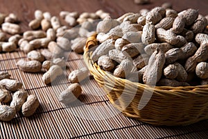 Large grains of peanuts in the shell and basket