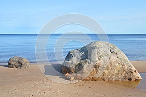 Large granite boulder on coast of lake photo