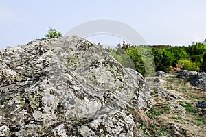 Large granite rocks covered with old moss are an inherent part of the harsh northern landscape of Sweden, Granna photo