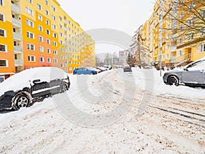 Large gray car buried under fresh snow after a night snowstorm