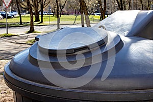 Large plastic trash can in the park