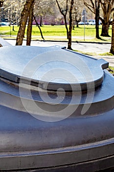 Large plastic trash can in the park