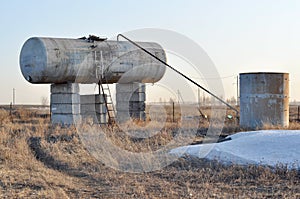 Large gray tank and well nearby