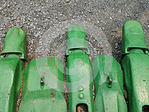 Large green metal excavating or mining machine part