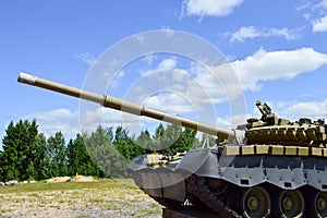 A large green military metal armored deadly dangerous iron Russian Syrian battle tank with a gun turret and a goose