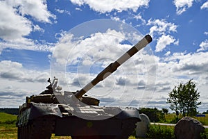 A large green military metal armored deadly dangerous iron Russian Syrian battle tank with a gun turret and a goose