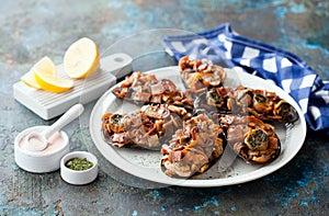 Large Grey baked mussels shells stuffed with fried bacon and mushrooms